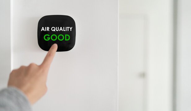 Homeowner monitoring indoor air quality with digital air quality sensor