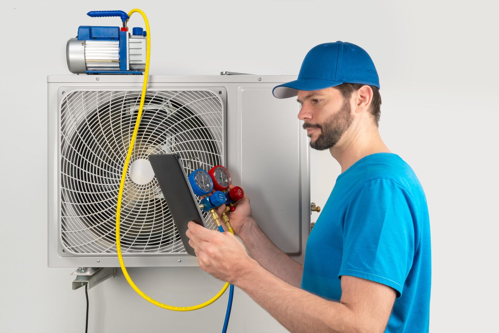 Professional HVAC technician inspecting air conditioning system outdoors