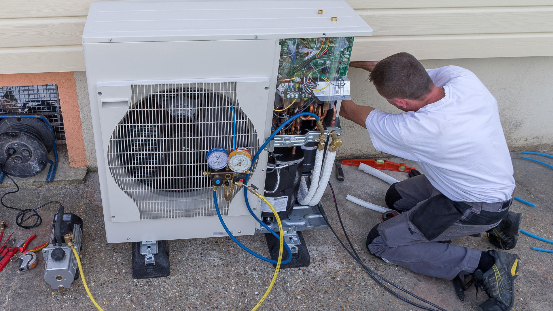 Technician replacing outdated home heating system for improved energy efficiency